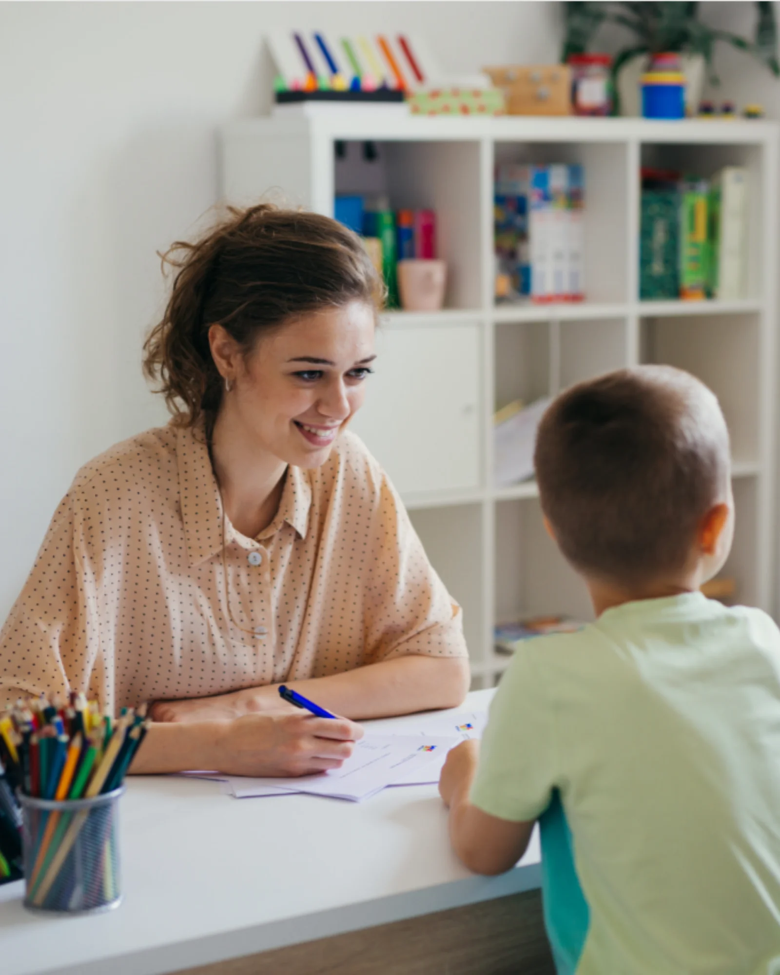 A clinician working one-on-one with a child during an ADHD evaluation